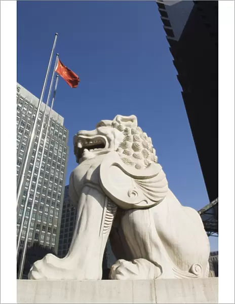 A stone lion statue in the Central Business District business district, Beijing, China, Asia