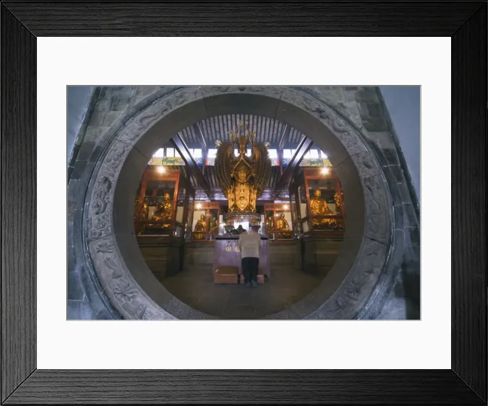 Framed Print : A woman praying in front of an arched entrance at West Garden Buddhist Temple Framed Print : A woman praying in front of an arched entrance at West Garden Buddhist Temple