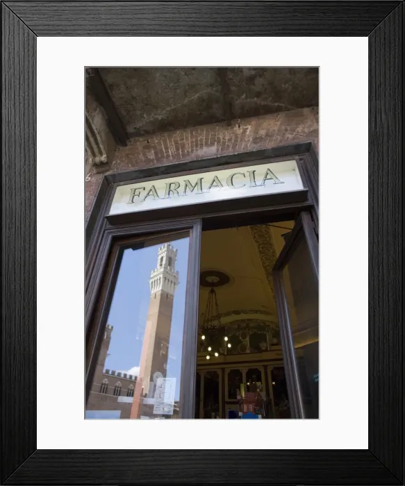 Framed Print : The tower of Palazzo Pubblico reflected in Farmacia window, Piazza del Campo Framed Print : The tower of Palazzo Pubblico reflected in Farmacia window, Piazza del Campo