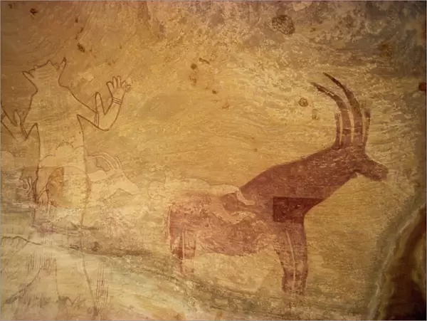 Huge painting of god figure and sable antelope on rock wall, Tassili Plateau