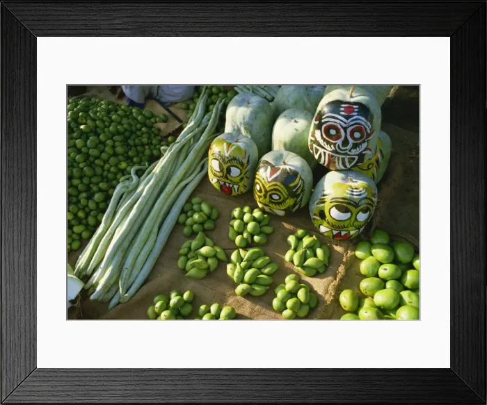 Framed Print : Green mangoes, snake gourds and squash painted with faces to hang in shop front to keep off evil spirits Framed Print : Green mangoes, snake gourds and squash painted with faces to hang in shop front to keep off evil spirits
