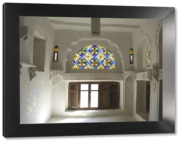 Traditional upper window of stained glass in upstairs room within the Dhar Alhajr