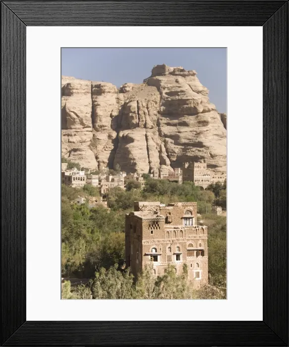 Framed Print : Traditional tall brick-built houses in village beneath sandstone cliff Framed Print : Traditional tall brick-built houses in village beneath sandstone cliff