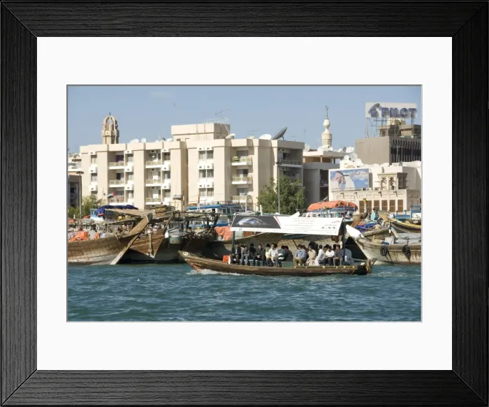 Framed Print : Abra (cross-creek ferry) chugs past dhow wharves and modern buildings of Deira Framed Print : Abra (cross-creek ferry) chugs past dhow wharves and modern buildings of Deira