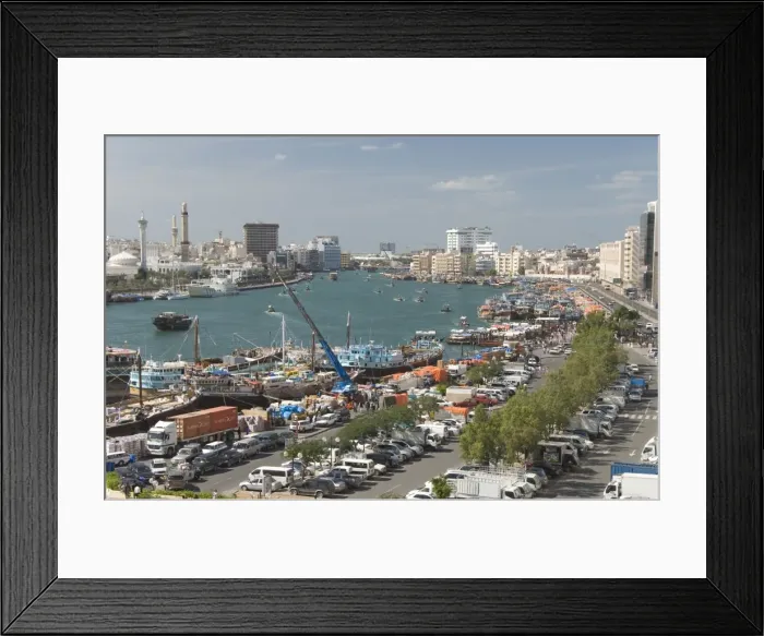 Framed Print : Dhows moored for unloading alongside Deira wharves, minarets of the Grand Mosque in Buer Dubai on right of creek, Dubai Creek, Dubai, United Framed Print : Dhows moored for unloading alongside Deira wharves, minarets of the Grand Mosque in Buer Dubai on right of creek, Dubai Creek, Dubai, United