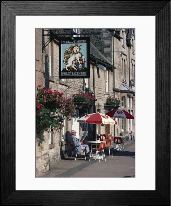 Framed Print : Visitor relaxes outside a typical pub, Stow-on-the-Wold, Gloucestershire Framed Print : Visitor relaxes outside a typical pub, Stow-on-the-Wold, Gloucestershire