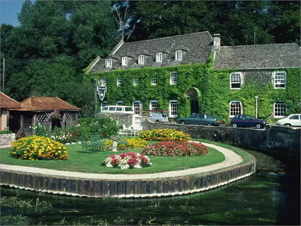 Swan Hotel on a bend in the River Coln, Bibury, Gloucestershire, The Cotswolds