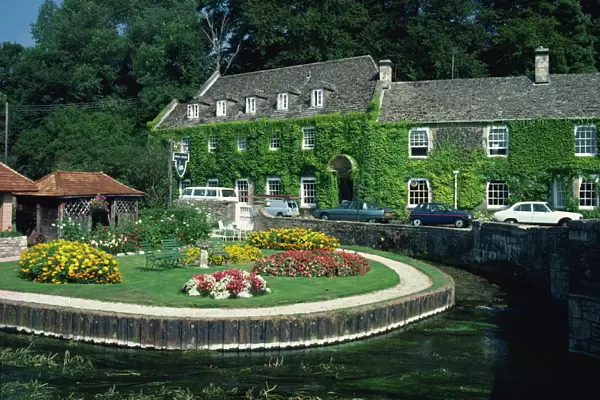Swan Hotel on a bend in the River Coln, Bibury, Gloucestershire, The Cotswolds
