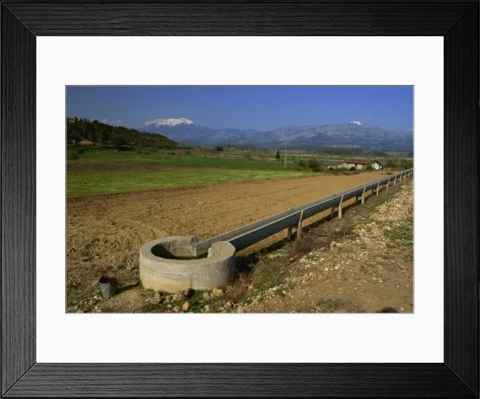 Framed Print : Irrigation channel in countryside near Kursunlu, with Kuyucak mountains in distance Framed Print : Irrigation channel in countryside near Kursunlu, with Kuyucak mountains in distance