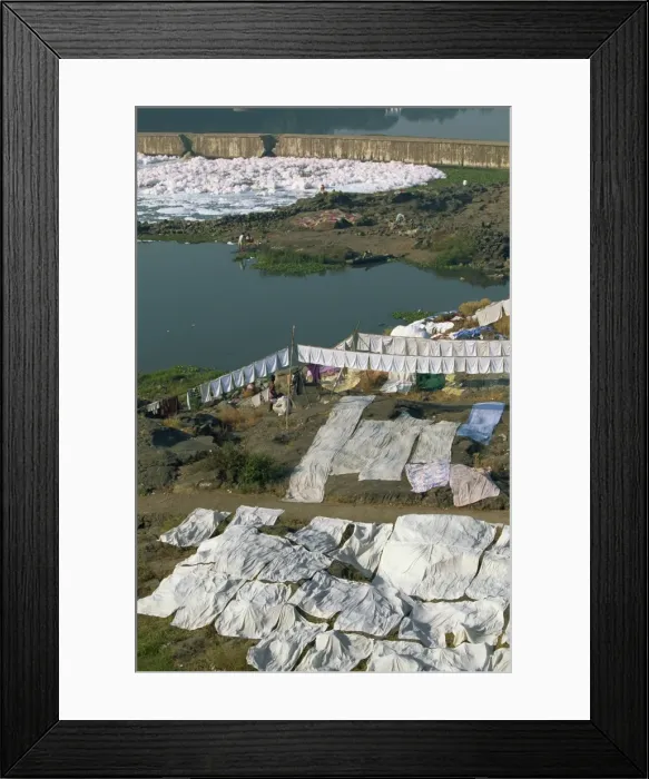 Framed Print : Laundry drying by the Mula River, with foam from detergent pollution beyond Framed Print : Laundry drying by the Mula River, with foam from detergent pollution beyond