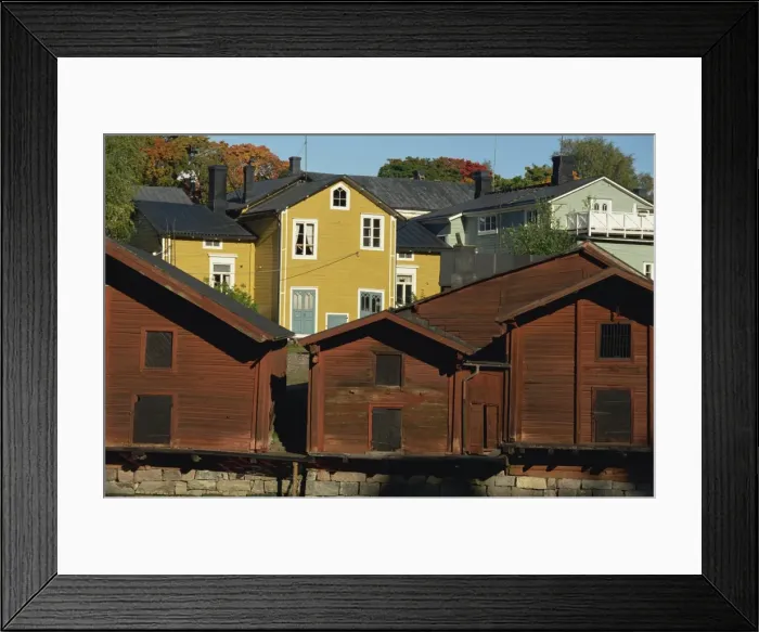 Framed Print : Typical heavy red of fishermens cottages and sheds lining the River Porvoo Framed Print : Typical heavy red of fishermens cottages and sheds lining the River Porvoo