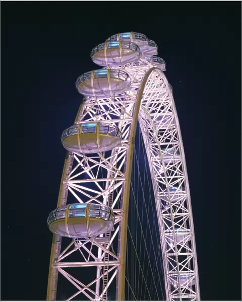 Illuminated by moving coloured lights, London Eye, architects Marks Barfield