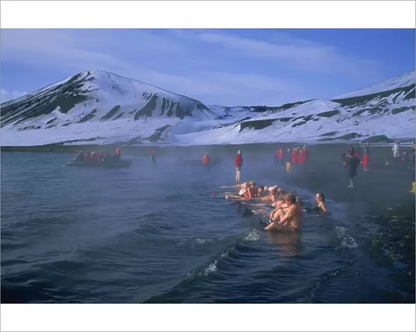 Tourists bathing in hot tub in dormant volcanic crater, Deception Island