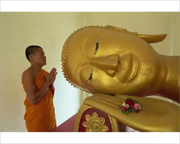 Novice monk and reclining Buddha, Wat Pha Baat Tai, Luang Prabang, Laos