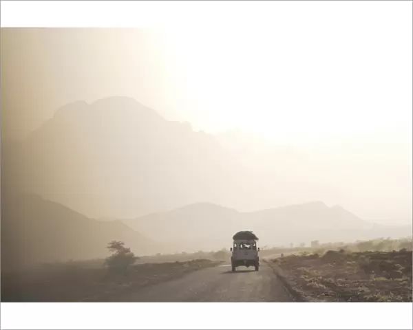 Land cruiser driving along dusty road, between Zagora and Tata, Morocco