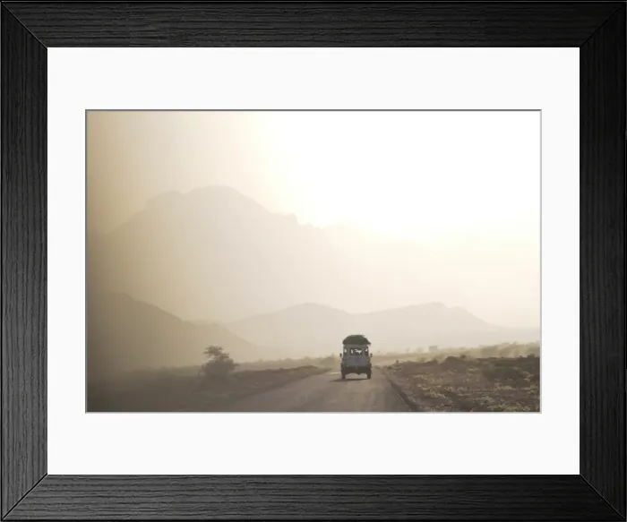 Framed Print : Land cruiser driving along dusty road, between Zagora and Tata, Morocco Framed Print : Land cruiser driving along dusty road, between Zagora and Tata, Morocco