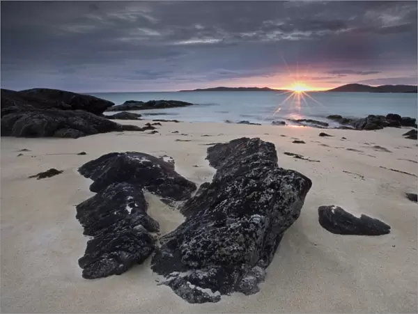 View towards Taransay at sunset from the rocky shore at Scarista, Isle of Harris