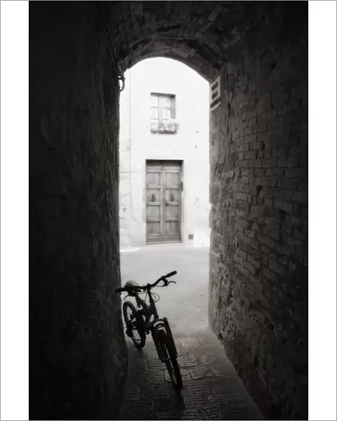 Infra red image of a bicycle in shady alleyway, San Quirico d Orcia