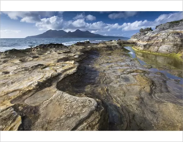 View towards Isle of Rum from rock formations at Laig Bay, Isle of Eigg