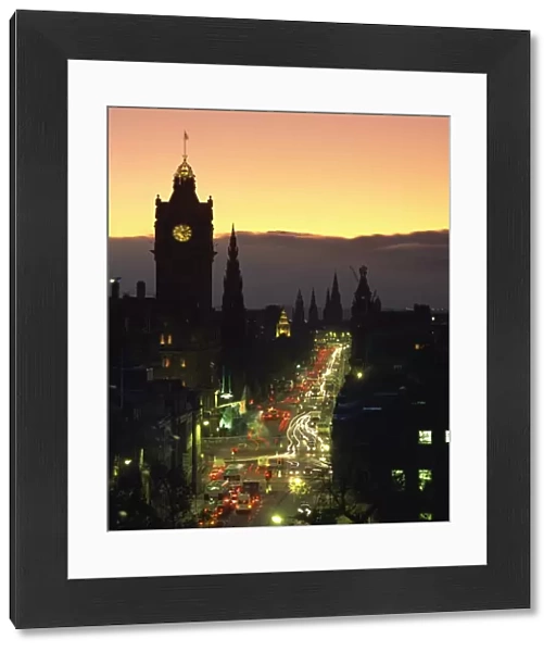 Aerial view over Princes Street at dusk, including the silhouetted Waverley Hotel clock tower