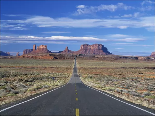 Straight road heading for Monument Valley, Navajo Reserve, on border of Arizona and Utah
