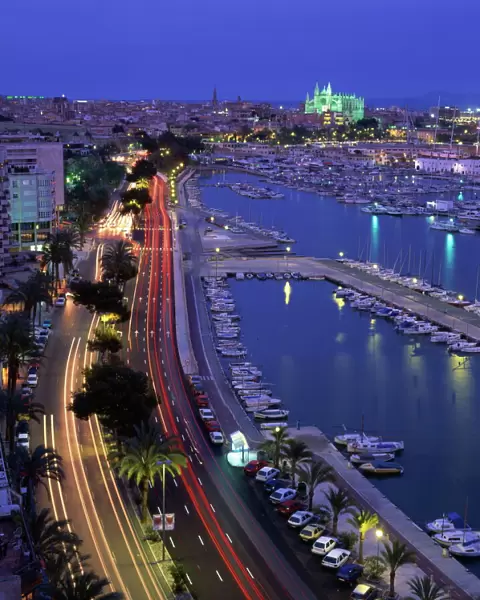 Lights at dusk, with boats in the marina and Palma cathedral across the bay