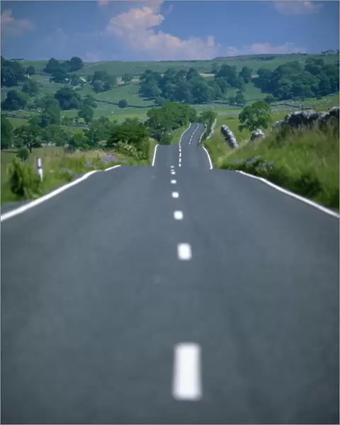 Undulating rural road through countryside, United Kingdom, Europe