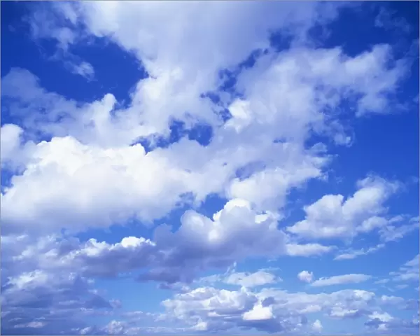 Cloudscape of puffy white clouds in a blue sky