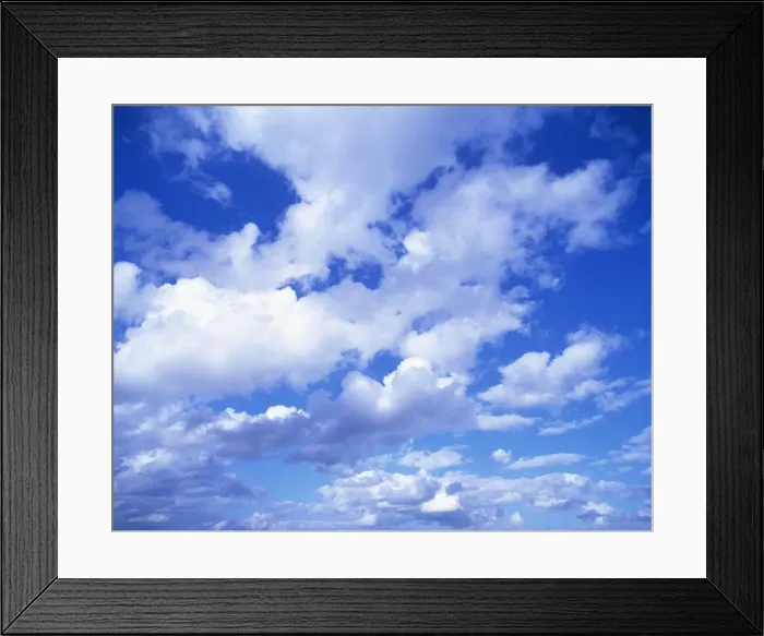 Framed Print : Cloudscape of puffy white clouds in a blue sky Framed Print : Cloudscape of puffy white clouds in a blue sky