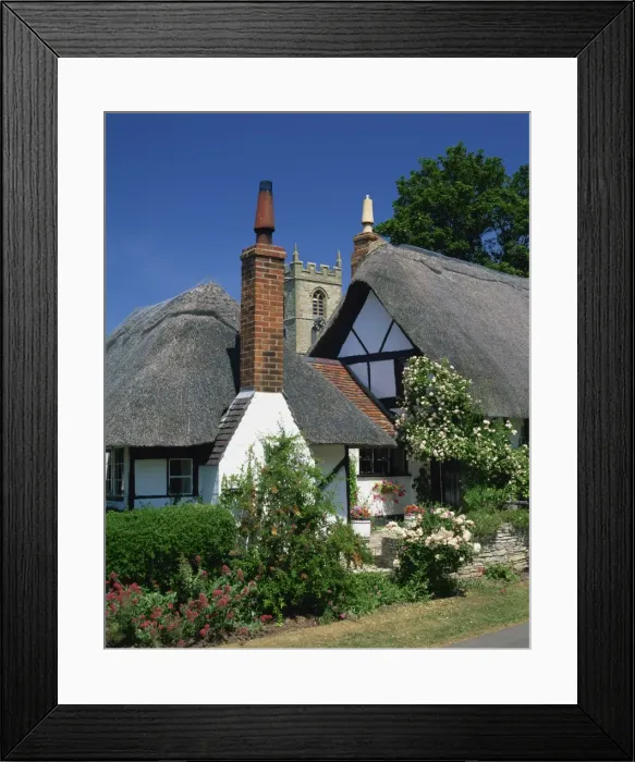 Framed Print : Thatched cottages, with the village church behind, at Welford on Avon in Warwickshire Framed Print : Thatched cottages, with the village church behind, at Welford on Avon in Warwickshire