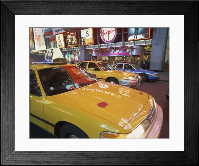 Framed Print : Yellow cabs on the street at night in Times Square, with Virgin Megastore in the background Framed Print : Yellow cabs on the street at night in Times Square, with Virgin Megastore in the background