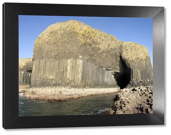 Columnar basalt lava with Fingals Cave cut into it by sea, Staffa
