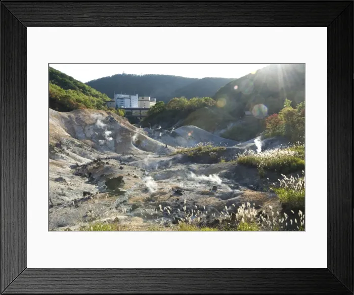 Framed Print : Steam vents in Jigokudani geothermal area, hotels of Noboribetsu Onsen beyond Framed Print : Steam vents in Jigokudani geothermal area, hotels of Noboribetsu Onsen beyond