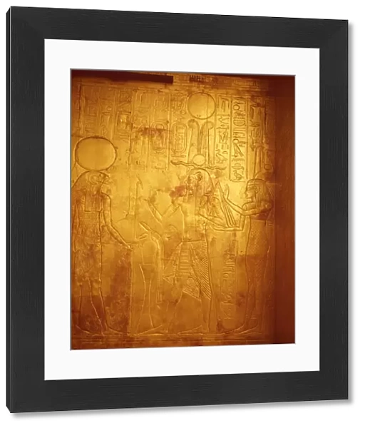 Detail of the king wearing Osiris crown with gods Reherakte and Maat on shrine of Tutankhamun