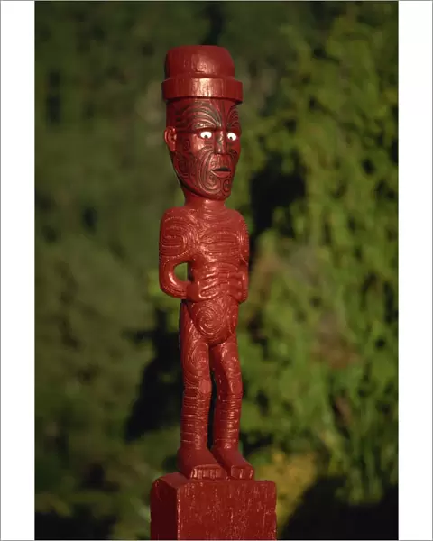 A carved figure or poupou in a Maori village at the Whakarewarewa thermal