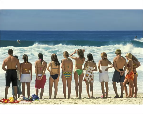Attractive young people in swim wear lined up for a photo on Sydneys iconic Bondi Beach in the Eastern Suburbs, Bondi, New South Wales