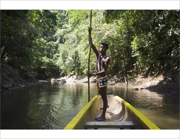 Embera Indian man in dugout canoe on Chagres River, Panama, Central America