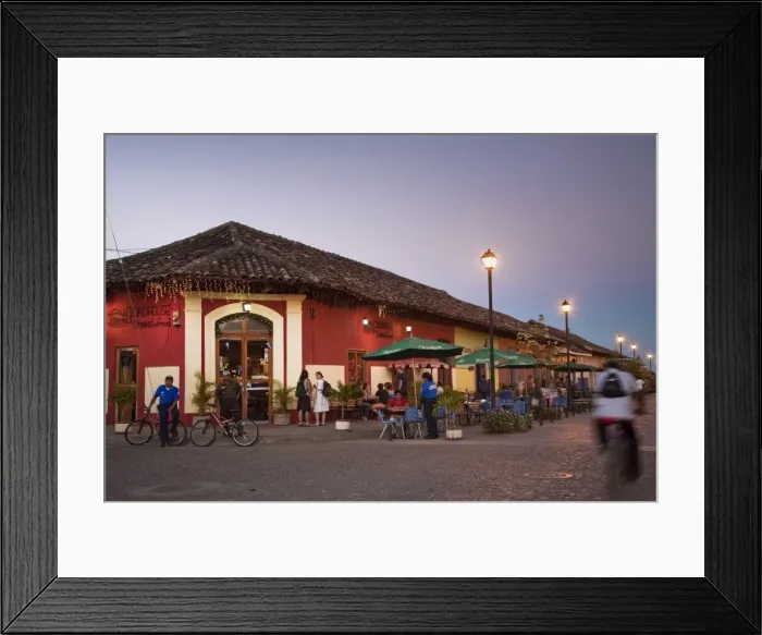 Framed Print : Man rideing bike past restaurant on Calle La Calzada, Granada, Nicaragua, Central America Framed Print : Man rideing bike past restaurant on Calle La Calzada, Granada, Nicaragua, Central America