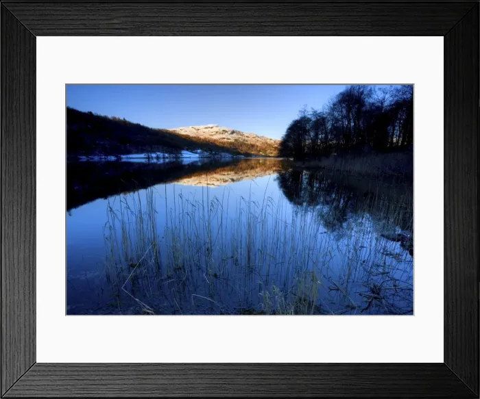 Framed Print : View across Grasmere on snowy winter morning with sunlight on distant fells Framed Print : View across Grasmere on snowy winter morning with sunlight on distant fells