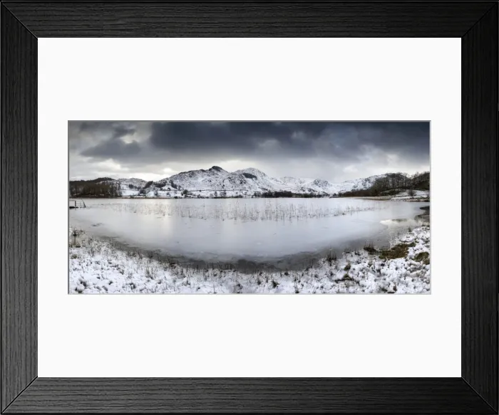 Framed Print : Frozen Little Langdale Tarn and snow-covered fells, near Ambleside, Lake District National Park