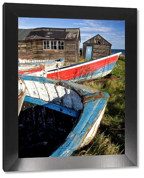 Old fishing boats and delapidated fishermens huts, Beadnell, Northumberland