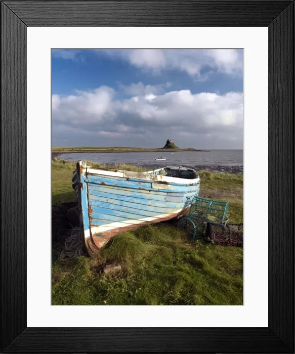 Framed Print : View towards Lindisfarne Castle with old fishing coble and lobster pots in the foreground Framed Print : View towards Lindisfarne Castle with old fishing coble and lobster pots in the foreground