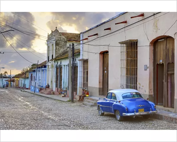 Cobbled street at sunset with classic American car, Trinidad, Cuba, West Indies