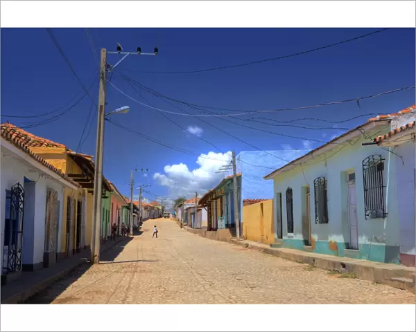 View along cobbled street lined with bright-painted houses, Trinidad, Cuba