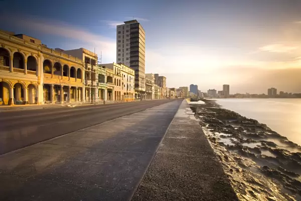 View along The Malecon at dusk showing mix of old and new buildings, Havana