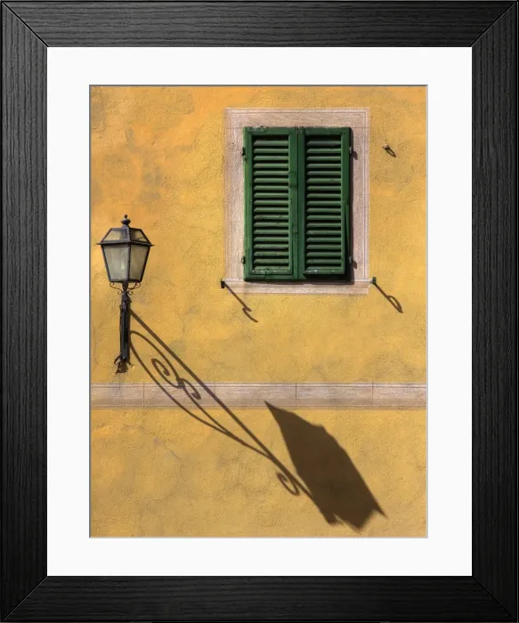 Framed Print : Architectural detail showing green wooden shutter on yellow wall with ornate wall lamp Framed Print : Architectural detail showing green wooden shutter on yellow wall with ornate wall lamp