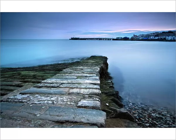 Stone jetty and new pier at dawn, Swanage, Dorset, England, United Kingdom, Europe