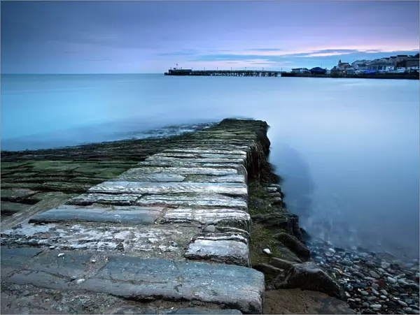 Stone jetty and new pier at dawn, Swanage, Dorset, England, United Kingdom, Europe