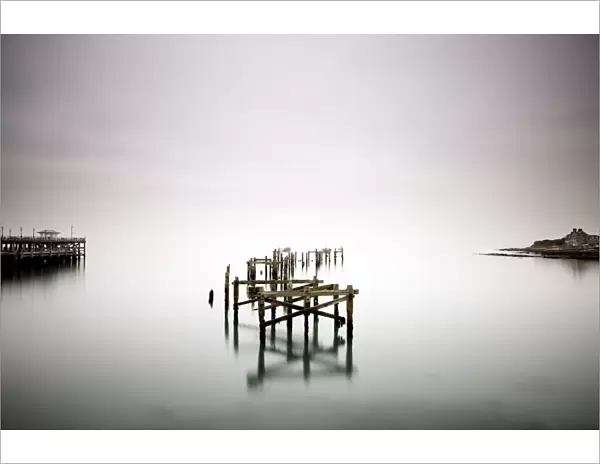Remains of the old pier on misty morning, Swanage, Dorset, England, United Kingdom