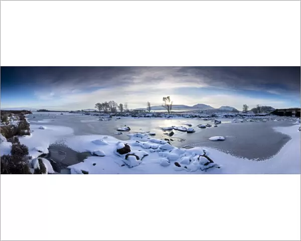 Panoramic winter view over frozen Loch Ba at dawn, Rannoch Moor, Highland
